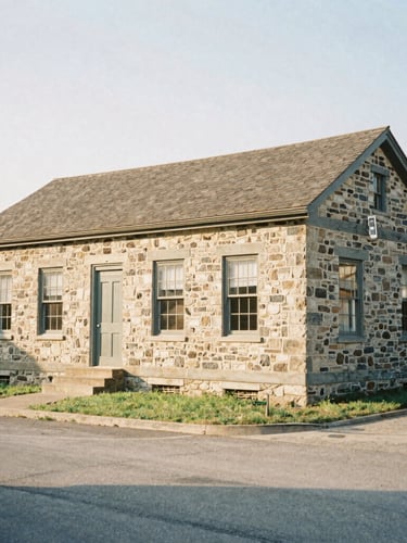 A wide historical archive photo of a stone schoolhouse in Lebanon, warm afternoon sun casting soft shadows, authentic 35mm film look, editorial documentary style.