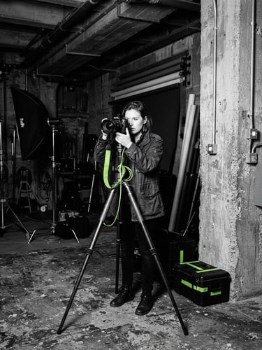 Stark editorial photography of a raw industrial concrete studio space in London, harsh direct flash, deep shadows, 35mm