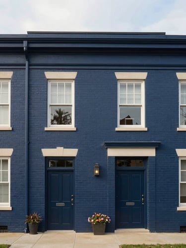 Straight-on architectural shot of a brick university-adjacent townhome under soft overcast morning daylight, clean lines, muted navy tones.