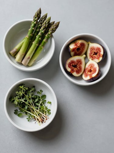 Overhead shot of three white ceramic bowls arranged on a pale grey prep surface — each containing a different seasonal ingredient: one with trimmed green asparagus, one with halved figs, one with herb sprigs — cool strobe lighting, no hands