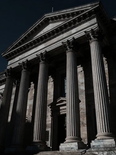 Low-angle heroic shot of classical legal architecture in deep shadow, sharp silver highlights, dramatic chiaroscuro lighting, obsidian tones, 35mm lens.