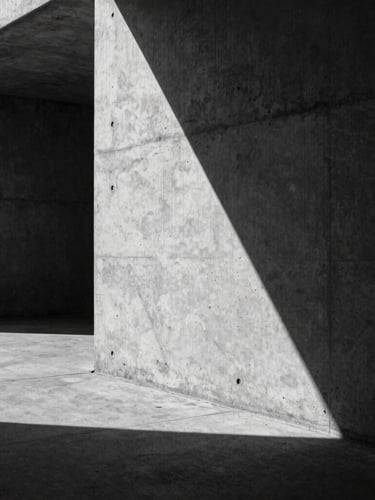 Cinematic architectural concrete texture in Berlin, sharp geometric shadows, high-contrast black and white, dramatic lighting, empty space on the left.