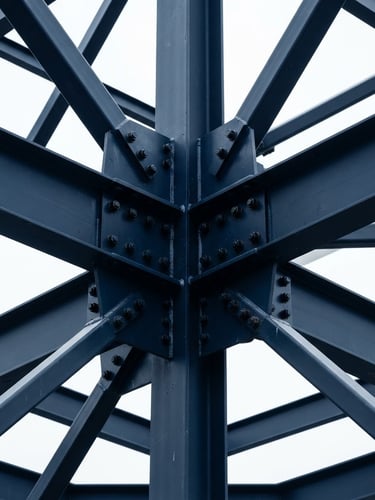 Crisp technical photography of structural steel joints under sharp overcast daylight, deep navy and stark white tones, architectural lens framing