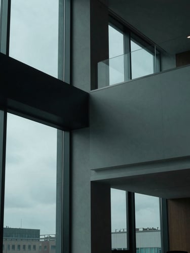 Abstract modern law office interior with high-contrast architectural lighting, cool overcast daylight filtering through large windows, deep teal shadows, professional and authoritative atmosphere, 35mm