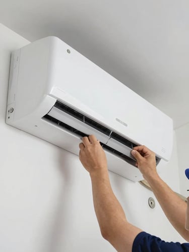 Close-up of a brand-new white wall-mounted split AC unit installed on a clean interior wall, technician's hands adjusting the unit's panel, daylight-balanced indoor lighting, sharp technical detail visible on vents and mounting plate
