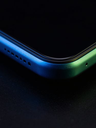 Extreme close-up macro shot of a sleek modern Android phone frame, metallic edges catching sharp electric-blue light, dark high-contrast tech photography, 35mm lens