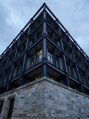 Wide-angle architectural photograph of a historic stone-and-steel civic building in London, crisp overcast sky, sharp structural focus.