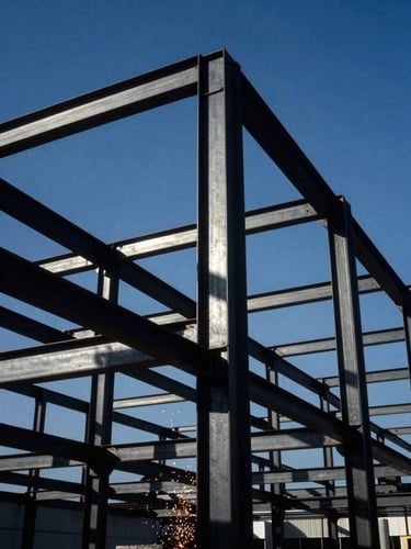 Low-angle shot of a massive structural steel frame erected against a clear blue Orlando sky, sharp shadows, high-contrast industrial photography