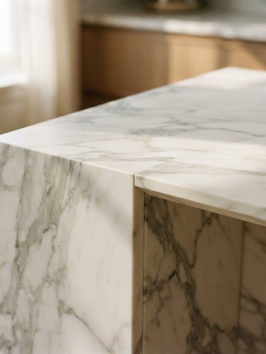 Close-up of a perfectly aligned Calacatta marble slab transition with crisp mitered edges, natural warm daylight, soft shadows, architectural detail