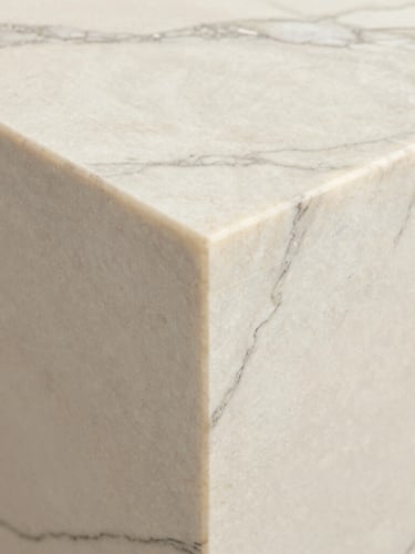Close-up detail of a mitered edge transition on a Calacatta marble slab, perfect grout-line alignment, soft natural side lighting, architectural detail