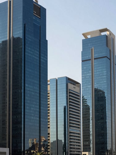High-end architectural view of Muscat's modern Al Mouj business district, bright natural Arabian daylight reflecting off glass facades, clean composition, deep navy tones.