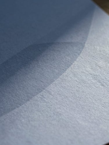 Macro close-up of textured high-quality heavy cotton paper with abstract geometric shadows cast across the surface, crisp natural light, elegant editorial feel