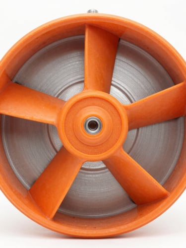 Close-up of a molded orange fiberglass fan impeller, seamless heavy-duty construction, high-contrast industrial studio lighting, sharp focus on composite textures, 50mm lens