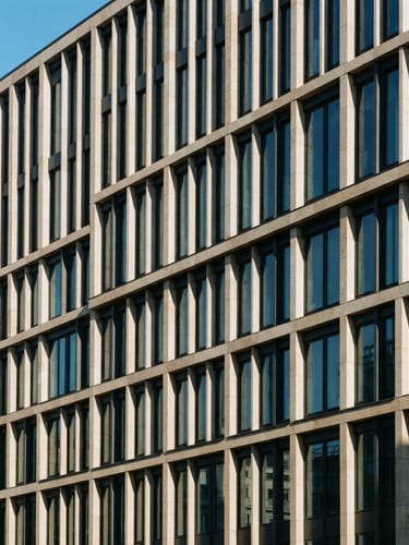 Architectural photograph of a modern office facade with clean geometric lines, crisp daylight casting structured navy shadows on warm stone, 35mm