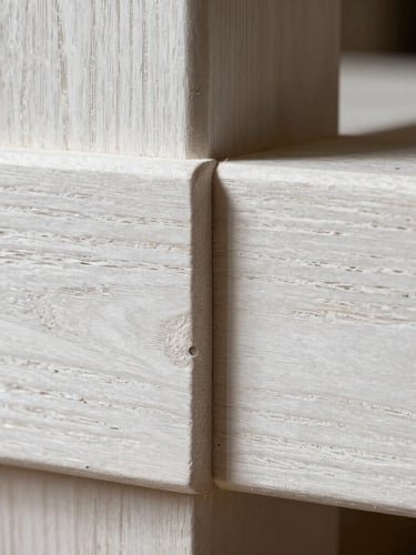 Macro architectural detail of a hand-carved white oak tenon joint, high-contrast natural workshop light catching the wood grain and fine chisel marks, strict flat elevation framing.