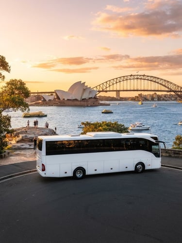Wide environmental shot of a pristine white luxury charter coach parked at Mrs Macquarie's Chair, Sydney Harbour Bridge in the golden hour background, bright editorial lighting.