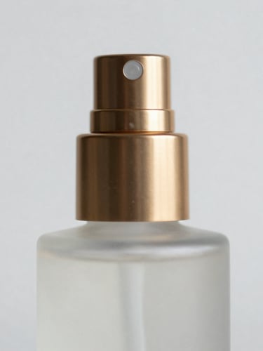 Macro close-up of a premium frosted glass cosmetic bottle with a metallic gold pump nozzle, soft shadows, architectural lighting, minimal composition