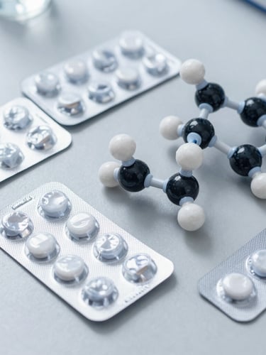 Precise overhead layout of blister packs and molecular models on a sterile slate grey surface, bright crisp laboratory daylight, sharp focus, clinical editorial composition
