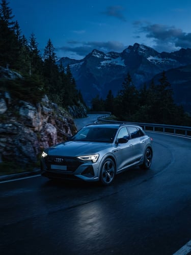 Sleek modern SUV driving during the blue hour on a mountain road, sharp focus, metallic reflections, deep blue tones, 35mm