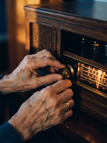 Close-up of wrinkled hands gently adjusting a vintage wooden radio dial, warm amber light glowing from the screen, 35mm film style.