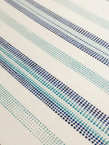 Close flatlay of a small pointillist panel, midnight blue and teal dots arranged in slow diagonal bands across ivory ground, diffuse studio light, sparse passages between bands leaving ground visible