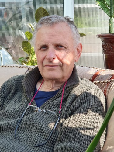 William at home at ease in chair.