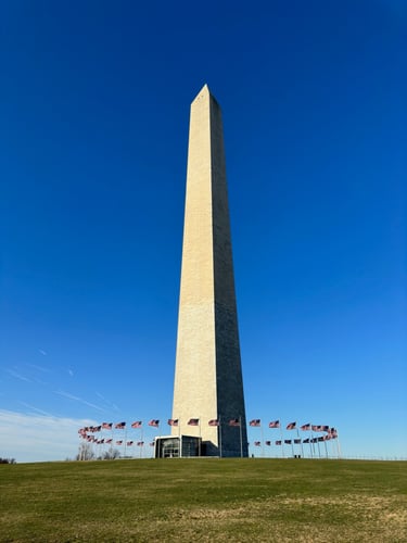 The Washington monument, an obelisk, in front of a blue sky