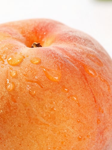 Extreme close-up macro shot of a sliced ripe heritage peach, glistening orange textures and juice droplets, bright high-key natural daylight, shallow depth of field