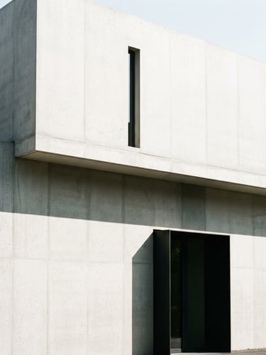 Minimalist architectural photography, bright daylight, clean concrete wall with sharp straight shadows, high-contrast, professional portfolio style, 35mm