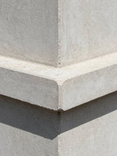 Macro close-up of architectural concrete angles under crisp natural daylight, sharp shadows, cool slate tones