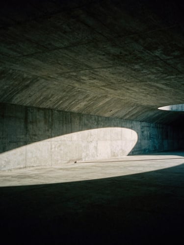Dramatic low-key editorial photography of an empty architectural concrete stadium tunnel, cinematic shadows, deep green tones, 35mm film grain