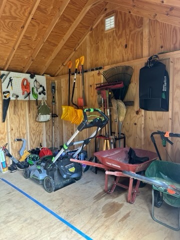 an organized shed with garden tools and equipment