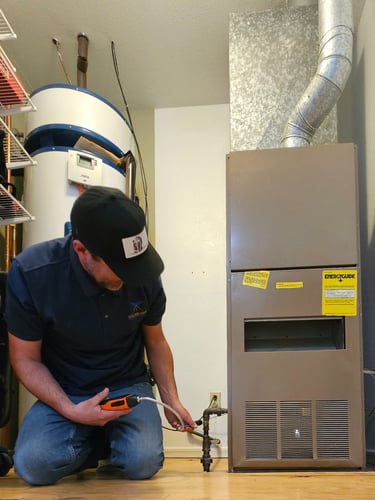 Felix checking for gas leaks on an older furnace