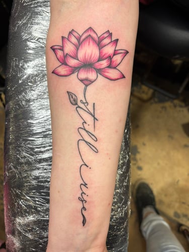 a tattoo of a lotus flower on a woman's arm