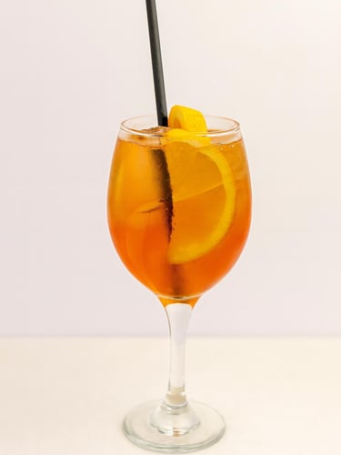 Aperol Spritz cocktail with orange slice served in wine glass for mobile bar hire London
