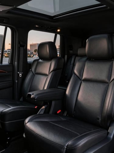 Close-up of a pristine black Cadillac Escalade interior, focusing on plush leather seating and executive space, sharp detail.