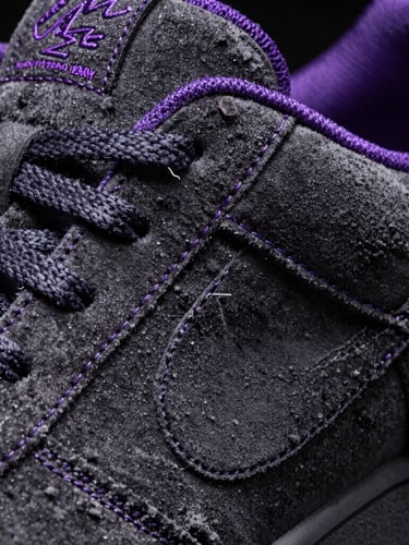 Macro extreme close-up of premium sneaker purple stitching and dark grey suede, sharp studio lighting, high contrast