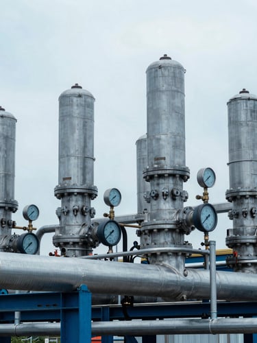 Industrial fuel cell testing facility, cool overcast daylight, sharp technical details of steel piping and pressure gauges, desaturated blue tones, 35mm