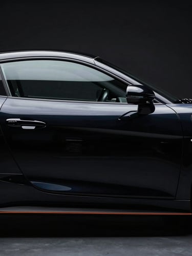 Sleek sports car side profile in a dark studio, dramatic key light highlighting sharp reflections on the glossy black paint, 50mm lens, high contrast