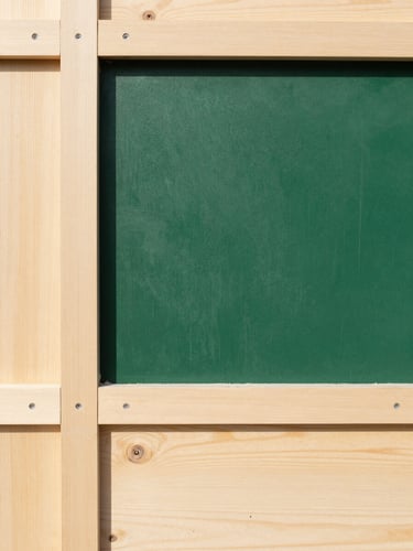 Straight-on architectural portrait shot of clean forest green paint texture next to light sustainable wood panels, bright natural daylight, 35mm lens