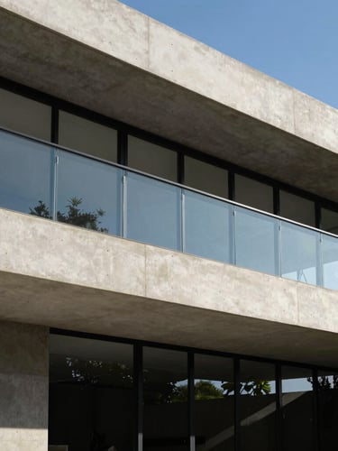 Sophisticated contemporary concrete and glass architectural lines, sharp shadows, soft natural daylight, luxury brazilian residence