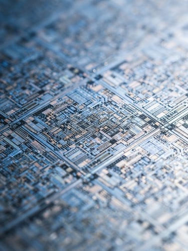 Extreme close-up of a high-resolution silicon wafer, cool blue and white studio lighting, sharp technical details, shallow depth of field, 50mm lens. The wafer shows intricate circuit patterns.