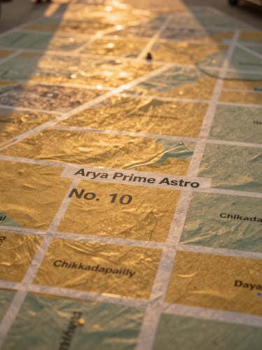 Overhead map view of Street No. 10 in Chikkadapally, Hyderabad, highlighting the location of Arya Prime Astro, warm golden-hour light, clear and professional.