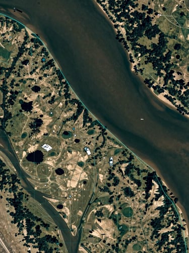 Top-down satellite orthomosaic of a river delta with sharp hyper-cyan vector grid lines overlaying the topography, natural atmospheric light, high-contrast shadow play, extreme nadir perspective.