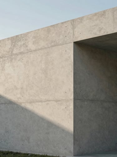 An architectural corner of a modern concrete studio in Miami, clean lines, pale warm gray surfaces, soft afternoon shadow, 35mm.