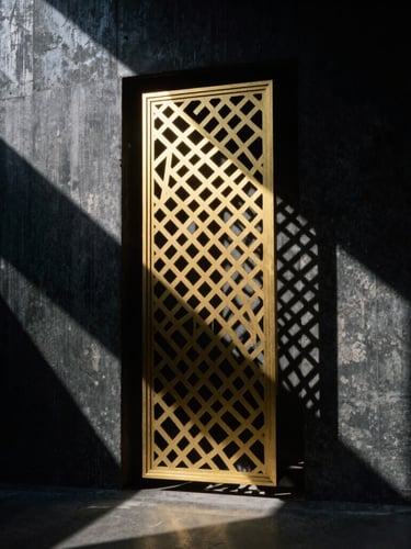 Dramatic architectural photography of a golden laser-cut metal screen casting geometric shadows on a dark concrete wall, high-contrast directional sunlight, 35mm