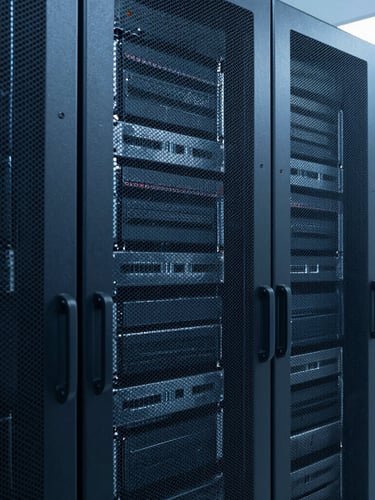 A vertical portrait of clean server racks in a modern data center, cool blue and slate tones, sharp focus, 35mm