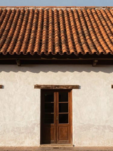 Wide shot of a traditional mid-market house facade in Zapopan, warm natural daylight hitting the terracotta tile roof, clean architectural lines, no people.