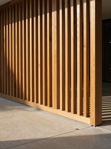 Architectural teak privacy screen casting sharp geometric shadows on a warm concrete patio, late-afternoon direct sunlight, 35mm editorial photography