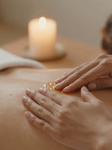 Close-up of hands applying warm essential oil on skin, soft candlelit ambiance, warm sand tones, shallow depth of field, 35mm film aesthetic